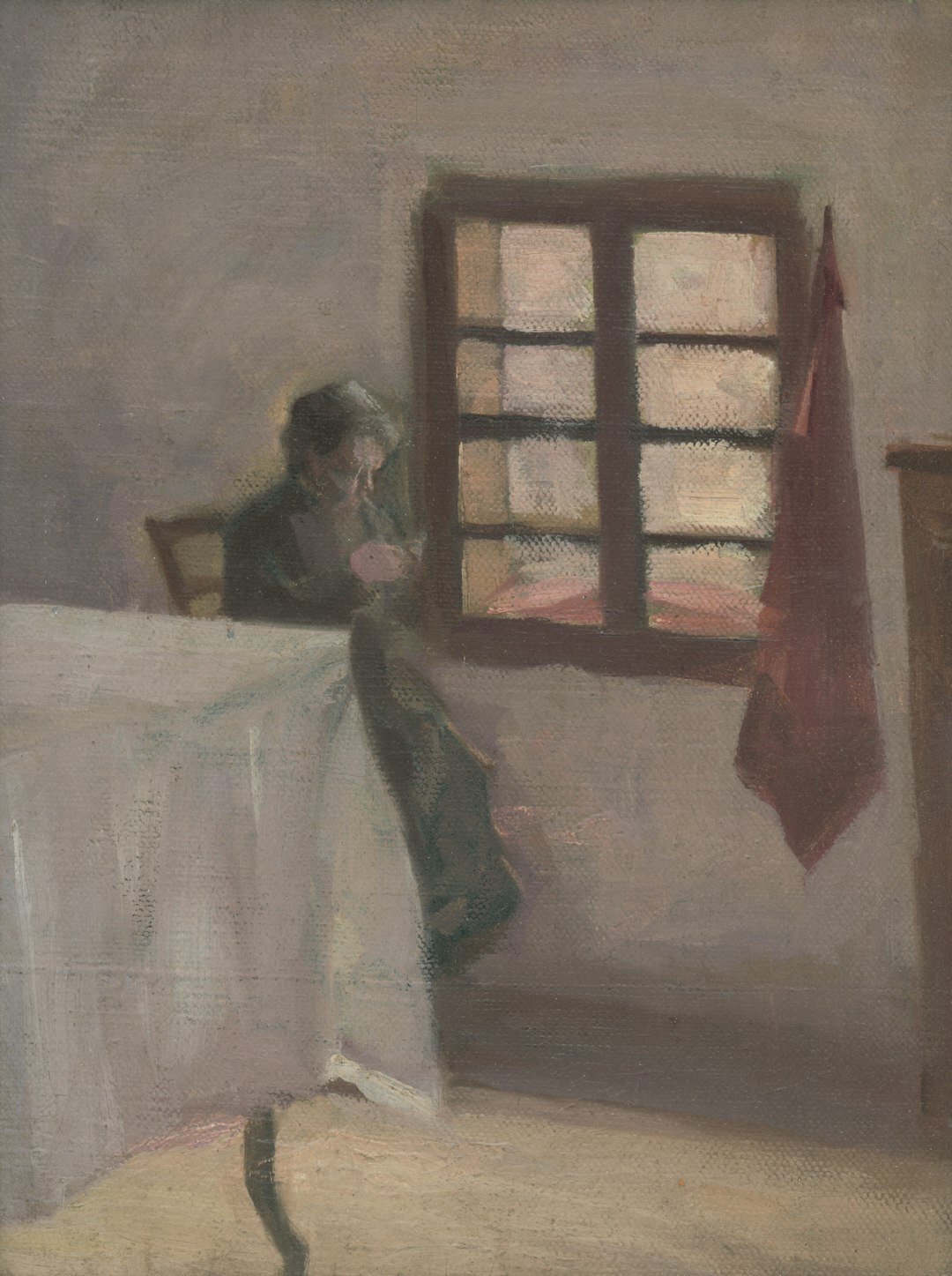 Elderly Danish woman knitting by a window in a warm domestic interior